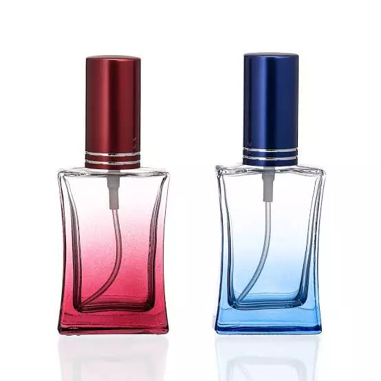 Two empty gradient spray bottles in red and blue