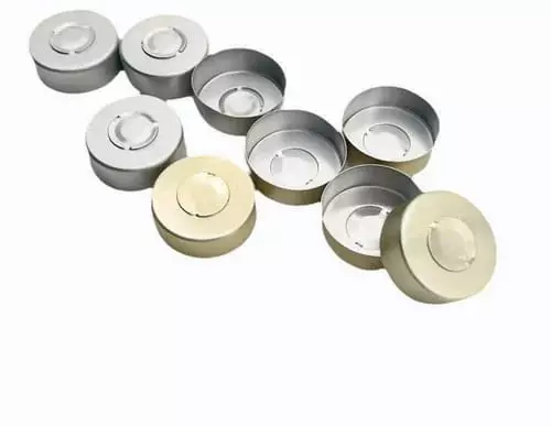 Metal vial caps in silver and gold on a white background