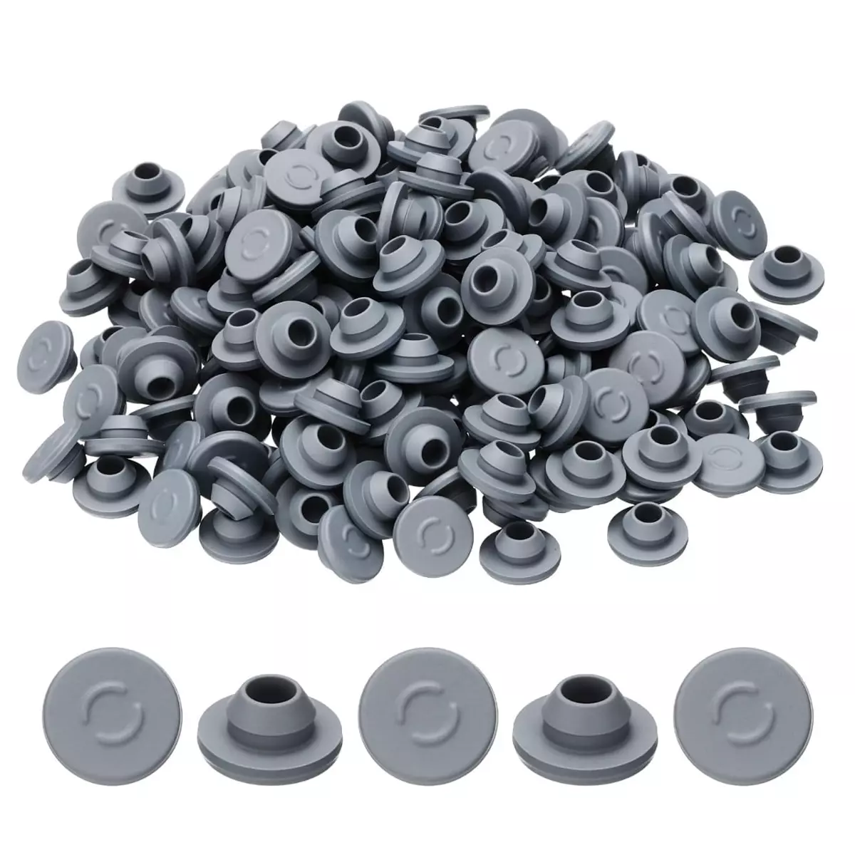 Pile of grey rubber vial stoppers with individual stoppers lined up